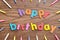Happy birthday in colorful letters with a collection of birthday candles