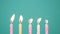 Happy Birthday concept Made of Burning Colorful Candles on blue or turquoise background. Blowing out 5 years anniversary