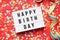 Happy birthday flat lay design with lightbox sign and confetti