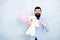 Happy birthday. go for present shopping. brutal bearded hipster in formal wear. businessman hold bear toy and balloon