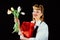 Happy birthday. Happy woman with present and flower. Girl with tulips and red surprise box on black background. Womens
