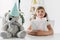 happy birthday kid sitting with present at table with teddy bear