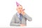 Happy birthday mature man with party hat blowing