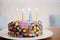 Happy Birthday sign and candles on child candy cake