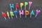 Happy Birthday text with candle letters over black sand