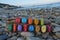 Happy Birthday text composed with multi colored stone letters on wood over a rocks beach