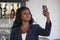 Happy black afro american woman in casual elegant clothes taking selfie portrait photo with mobile phone