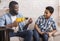 Happy Black Boy Learning From Father How To Use Electric Drill