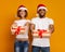 Happy black couple holding cool Christmas gifts