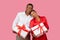 Happy black couple with white gift boxes, red ribbons, man in white, woman in red