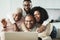 Happy black family doing video call at home - Main focus on father face