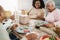 Happy black family eating lunch at home - Father, daughter, son and mother having fun together sitting at dinner table - Main