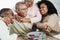 Happy black family eating lunch at home - Father, daughter, son and mother having fun together sitting at dinner table - Main