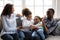 Happy black family laughing playing tickling children at home