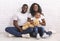 Happy Black Family With Little Son Sitting On Floor Together