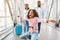 Happy black family traveling with daughter, having fun in airport