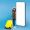 Happy black female traveler walking with suitcase, smartphone with mockup