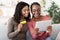 Happy black girls shopping online, using digital tablet at home