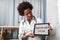 Happy black healthcare worker holding digital tablet and making Hippocratic oath