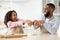 Happy black man and his child daughter preparing dough