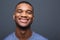 Happy black man smiling on gray background