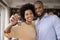 Happy Black millennial couple showing keys, smiling at camera