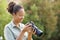 Happy black photographer checking camera