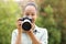 Happy black photographer looking at camera