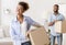 Happy Black Spouses Carrying Packed Boxes Into New Apartment