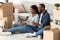 Happy Black Spouses Choosing Furniture Online With Digital Tablet And Credit Card