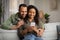 Happy Black Spouses Using Cellphone Texting At Home