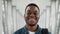 Happy Black Tourist Guy Smiling To Camera Standing In Airport