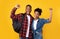 Happy Black Tourists Couple With Backpacks Gesturing Yes, Yellow Background