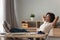 Happy black woman relax in chair at desk at home