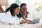Happy black women in bathrobes using laptop at home, websurfing