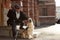 Happy blind male entertains his guide dog
