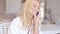 Happy Blond Female Calling at Phone Looking Left