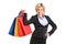 A happy blond female holding shopping bags