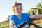 Happy blond guy in straw hat and and blue t-shirt