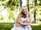 Happy blond young woman in park smiling, floral close up