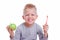 Happy blonde kid boy smiling with green apple and toothbrush on white background. Health care, dental hygiene, brushing