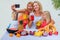 Happy blonde mother and her daughter enjoy making and drinking smoothies together in Bali. caucasian family in the