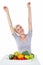 Happy blonde woman cheering while sitting above healthy food