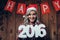 Happy blonde woman holding 2016 numbers