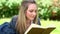 Happy blonde woman reading a book