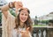 Happy bohemian woman tourist framing with hands in Prague