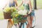 Happy boho chic girls ride together on bicycles in park