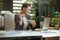 happy bookkeeper woman in green office eating salad