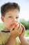 Happy boy biting the apple, A child with a fruit. Kid eating fresh pear