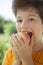 Happy boy biting the apple, A child with a fruit. Kid eating fresh pear